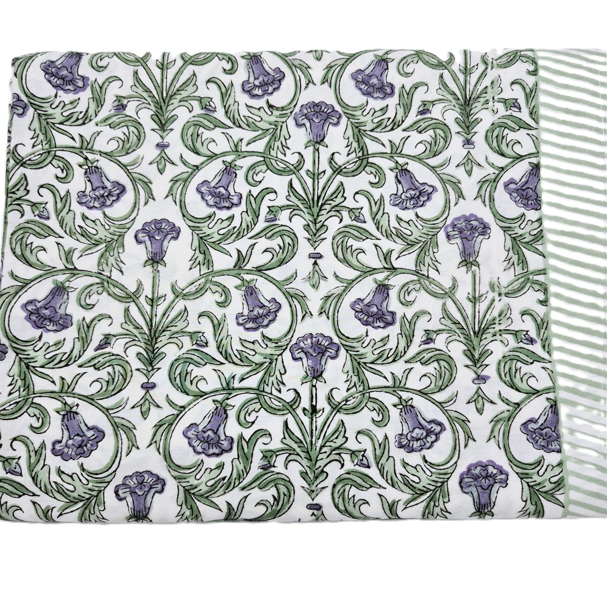Block print tablecloth with violet flowers and green leaves on a white background
