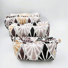 Tribal geometric block-print wash bag in tan, taupe, grey and black