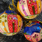 Papier-mache Christmas bauble hand-painted with whimsical winter houses