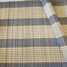 A natural bamboo placemat or table mat with navy blue stripes