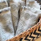 Striped bamboo basket holding folded face towels