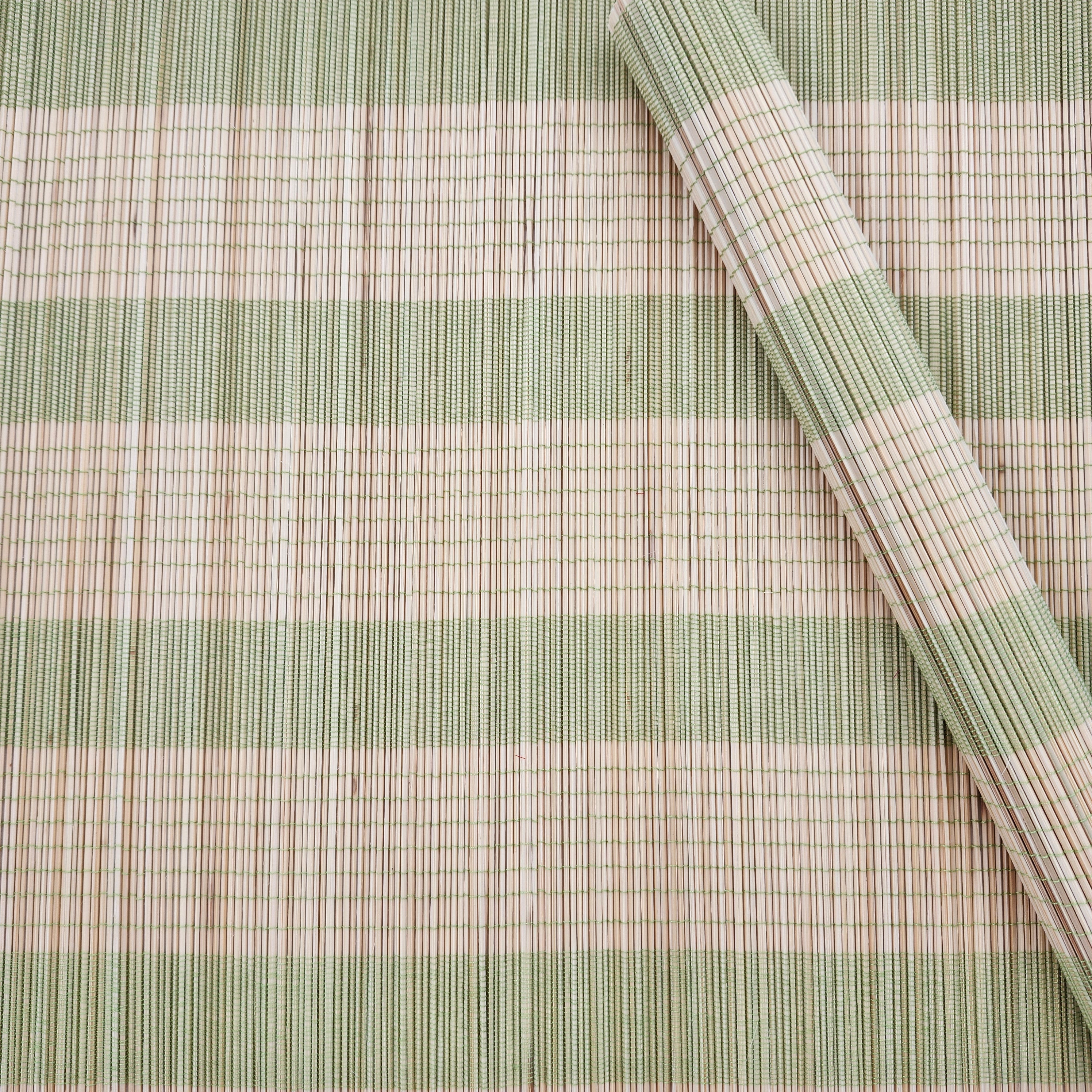 A Bamboo placemat with lime green stripes