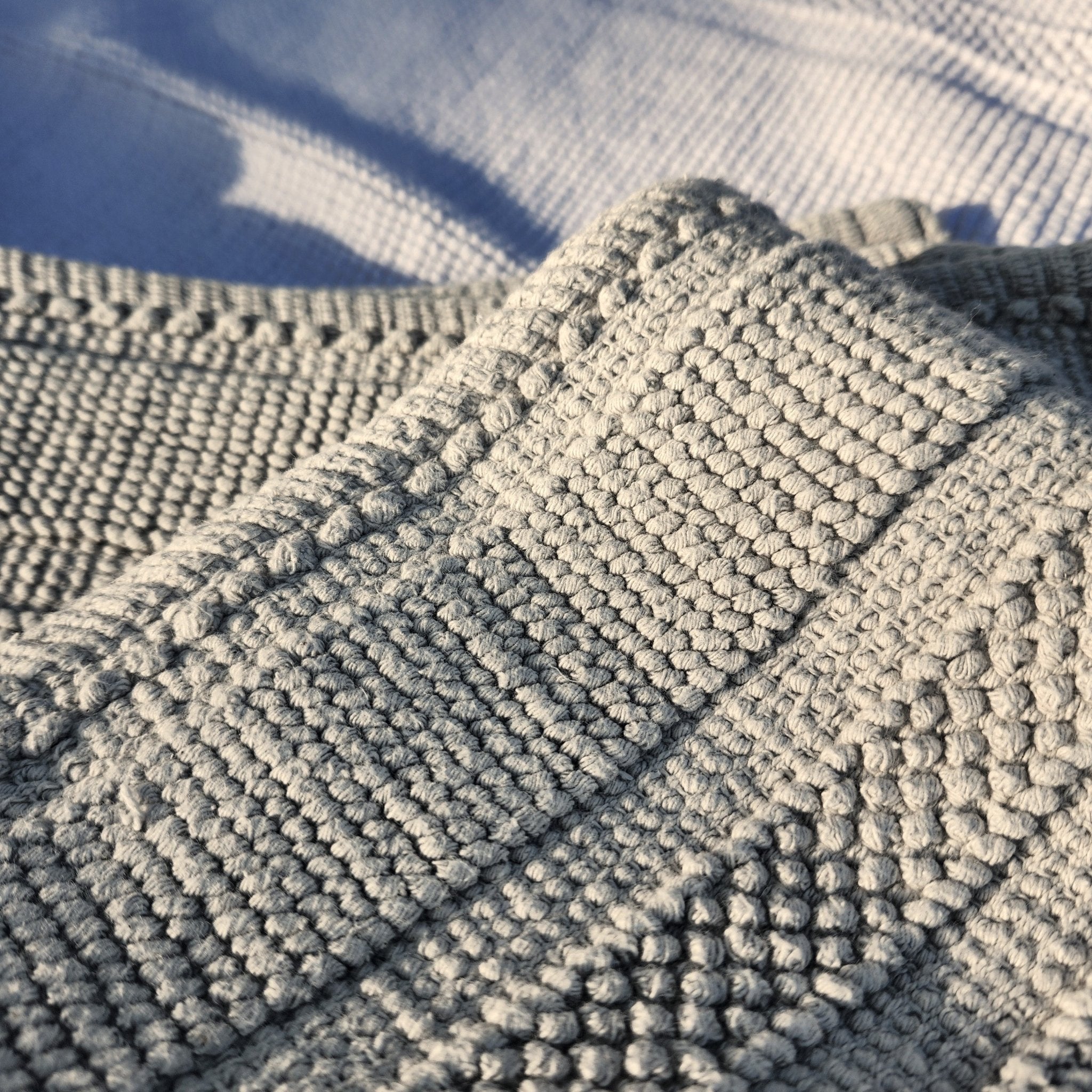 Light grey woven cotton bath mat, soft looped weave, 100% cotton
