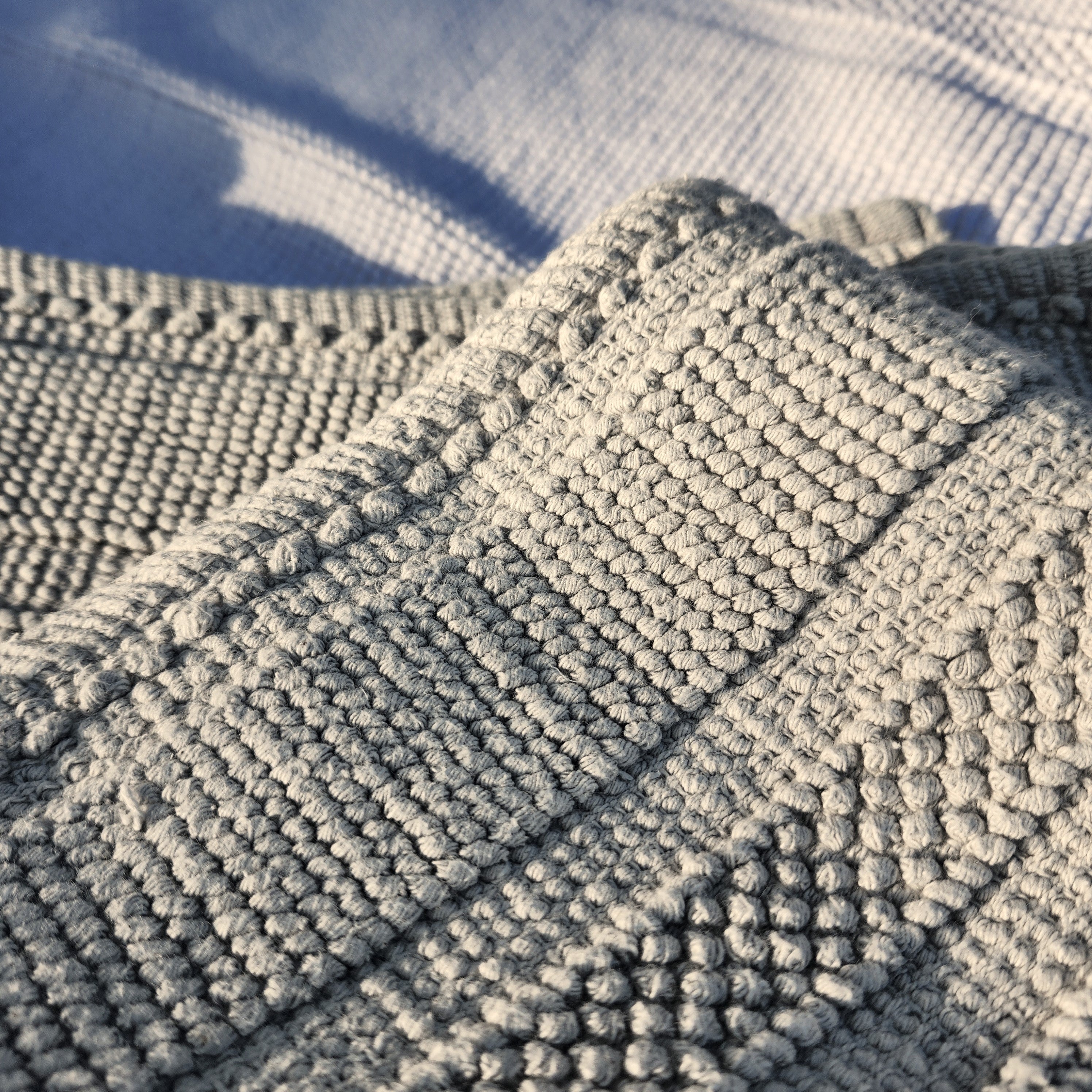 Light grey woven cotton bath mat, soft looped weave, 100% cotton