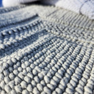 Woven cotton bath mat in light grey, looped weave, 100% stonewashed cotton