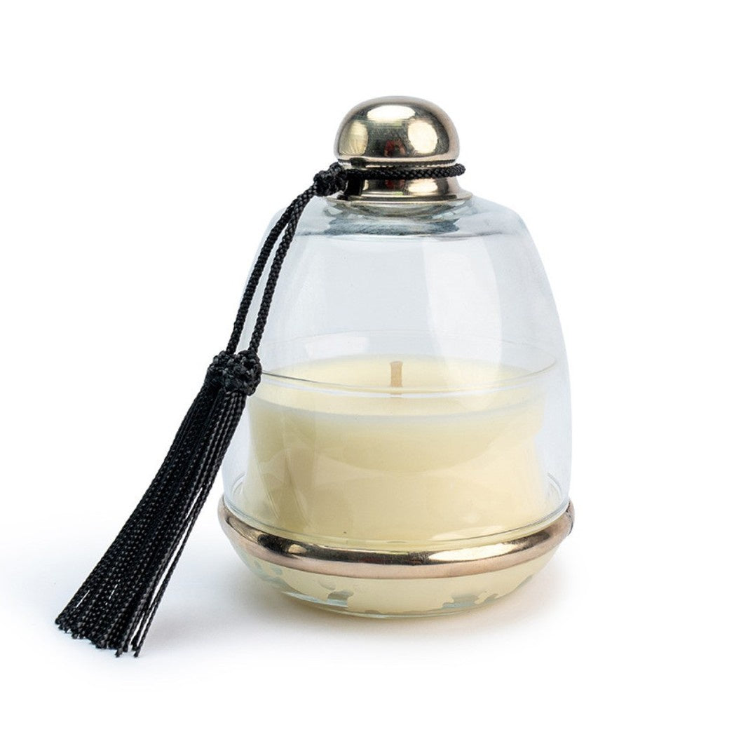 Cloche Atlas Cedar candle under bell-shaped glass lid with black tasselled knob, cedar scent