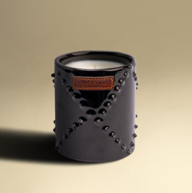 Nomad Atlas Cedar candle in black-glazed handmade ceramic jar, cedar wood scent