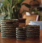 Raphia Mona Dates candle in natural, charcoal and olive raffia, date and patchouli scent