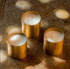 Cote Bougie Christmas gift set of three travel candles in hammered brass holders, pine and cypress scent