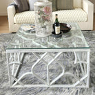 Carved mango wood trellis coffee table in distressed white with a glass top