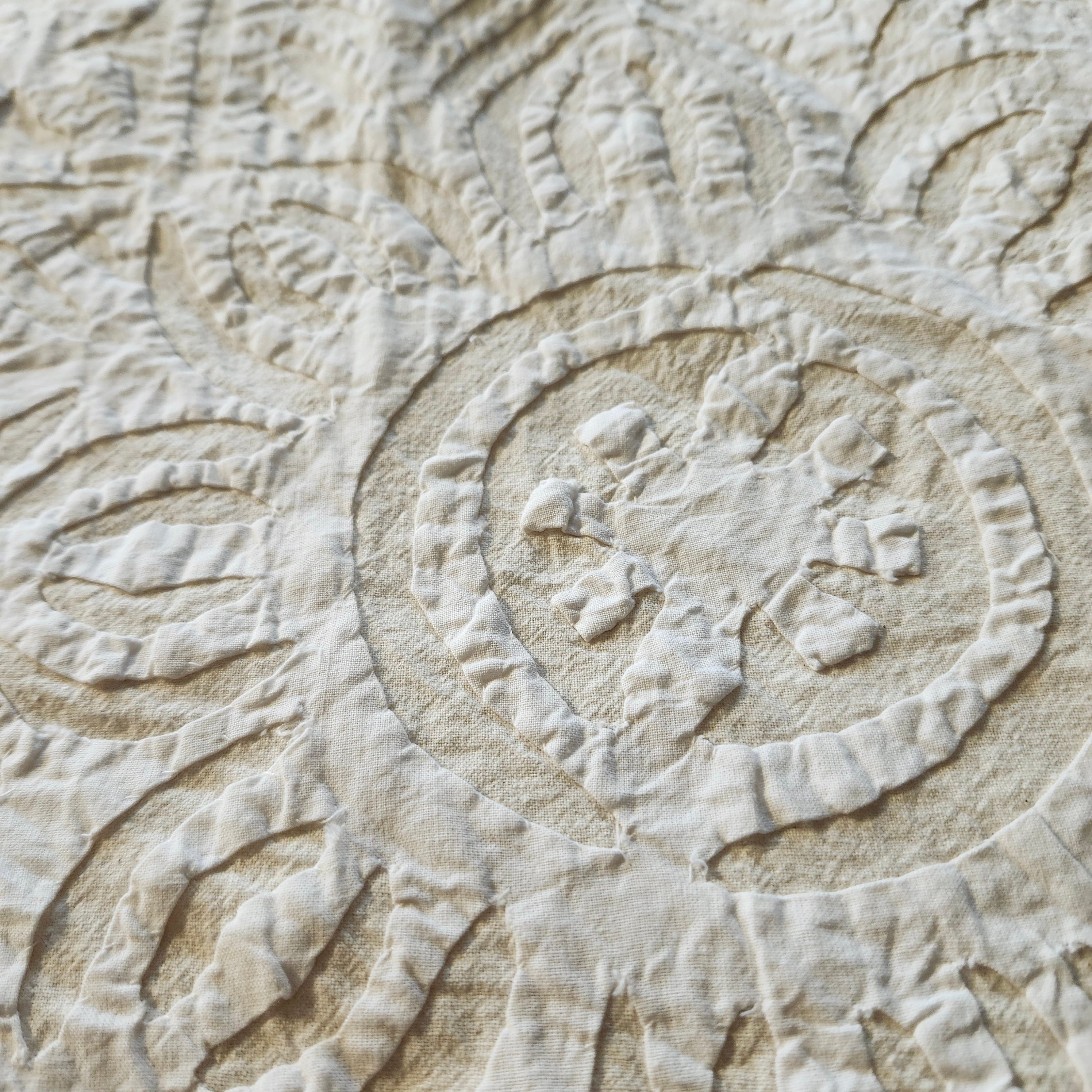 White cotton applique bedspread, cutwork detail, styled