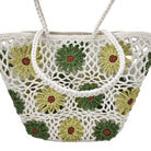A white crocheted beach tote bag featuring a pattern of sunflowers with green and yellow petals and brown centers, shown against a plain white background.