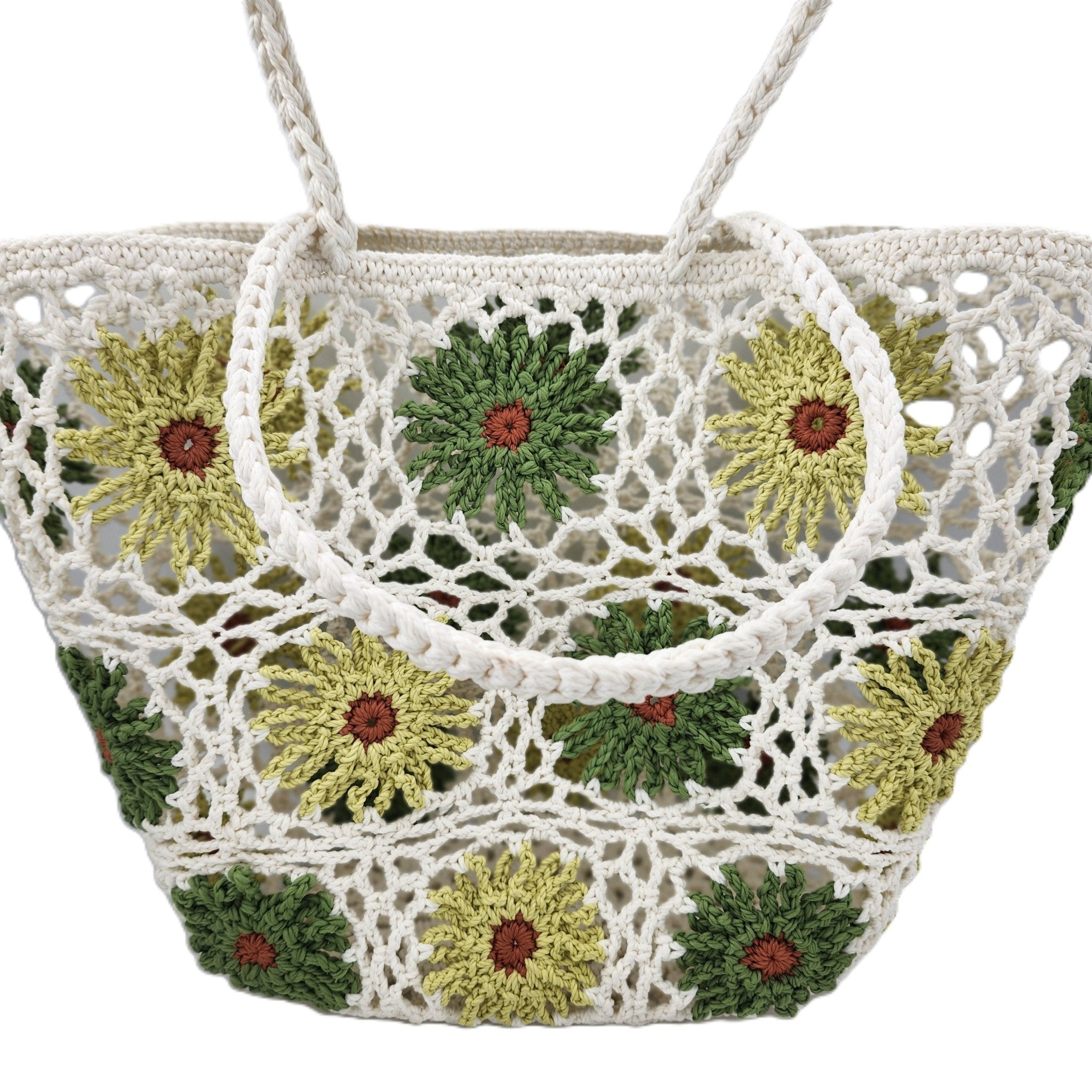 A white crocheted beach tote bag featuring a pattern of sunflowers with green and yellow petals and brown centers, shown against a plain white background.