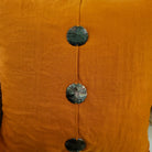 Turmeric linen cushion with three mother of pearl buttons, 60 x 60 cm