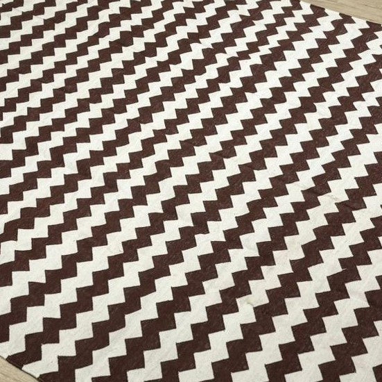 Cotton dhurry flat-woven rug with a brown and white zigzag pattern, 183 by 274 cm