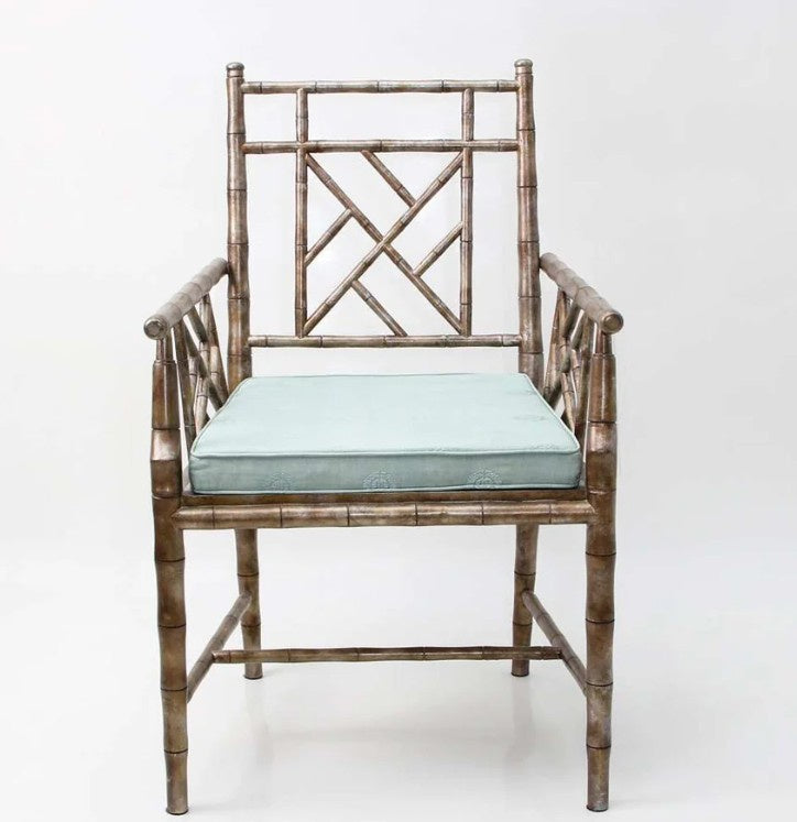Cora carver easy chair in acacia wood with antique bronze leaf and a teal cushion