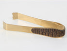 Ice tongs with a brass and faux crocodile finish