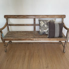 Vintage teak bench with cushions and throws, styled