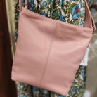 Ceannis small shoulder bag in dusty pink grained leather with adjustable strap