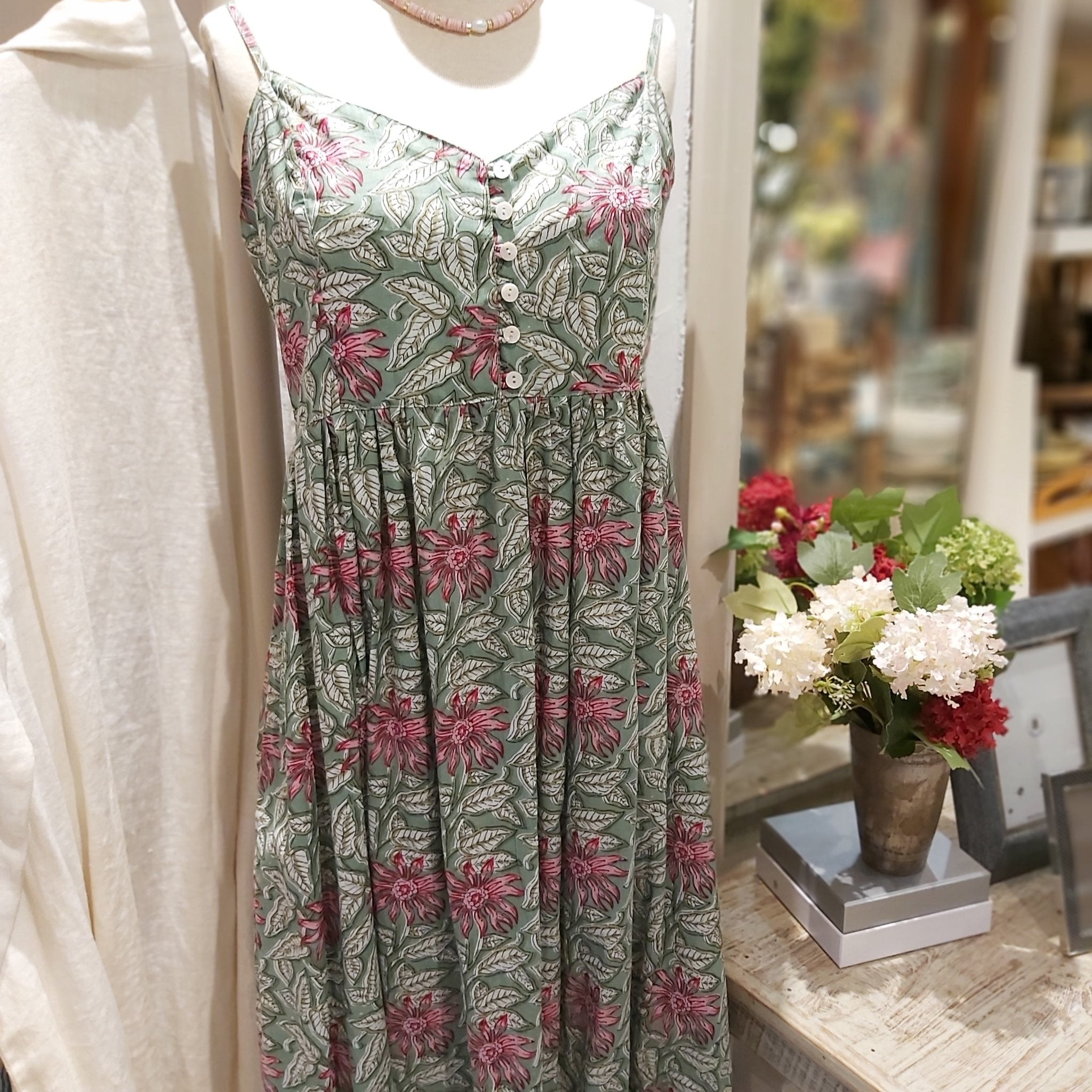 Block-print cotton sundress in a green floral pattern, one size