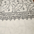 Creamy white pashmina with black floral hand embroidery, detail view