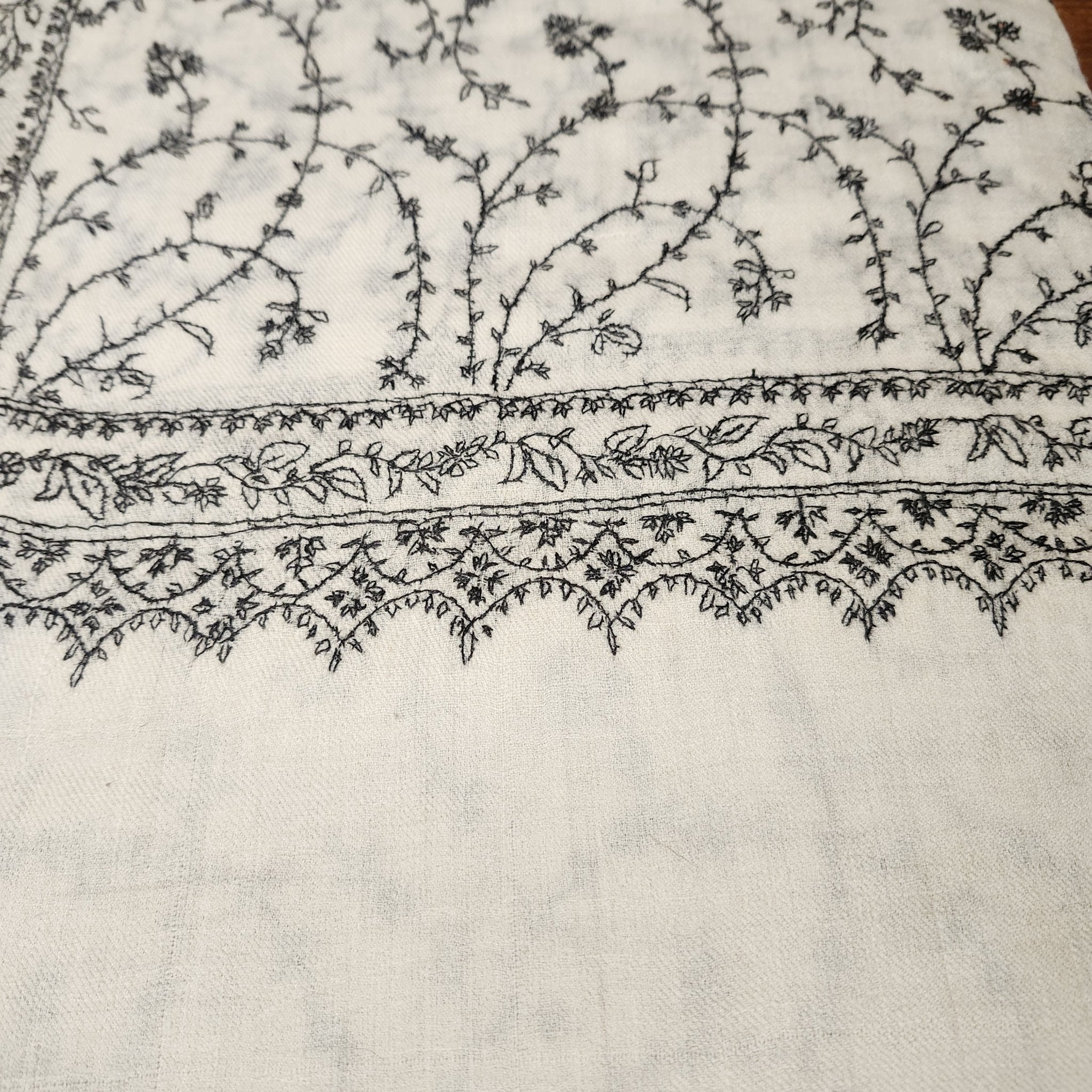 Creamy white pashmina with black floral hand embroidery, detail view