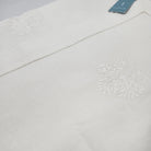 White cotton runner with a hemstitch border and floral embroidery, 40 x 200 cm