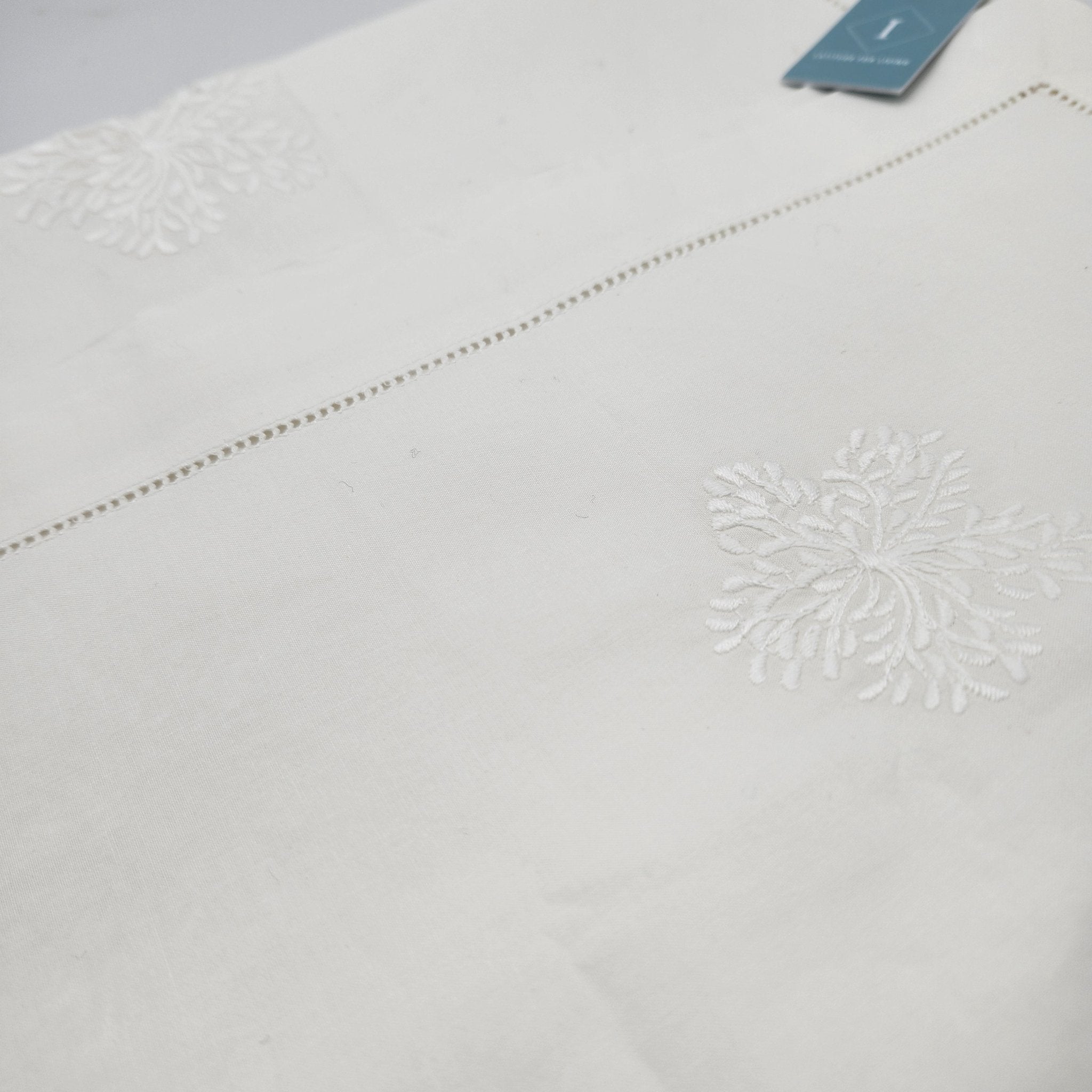 White cotton runner with a hemstitch border and floral embroidery, 40 x 200 cm