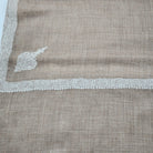 Natural white pashmina shawl with a hand embroidered border and a small motif, 70 by 200 cm, pure pashmina