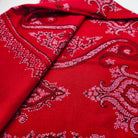 Red pashmina shawl with black and white hand embroidery, detail view