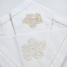 Beige floral hand embroidered white linen napkins, detail view