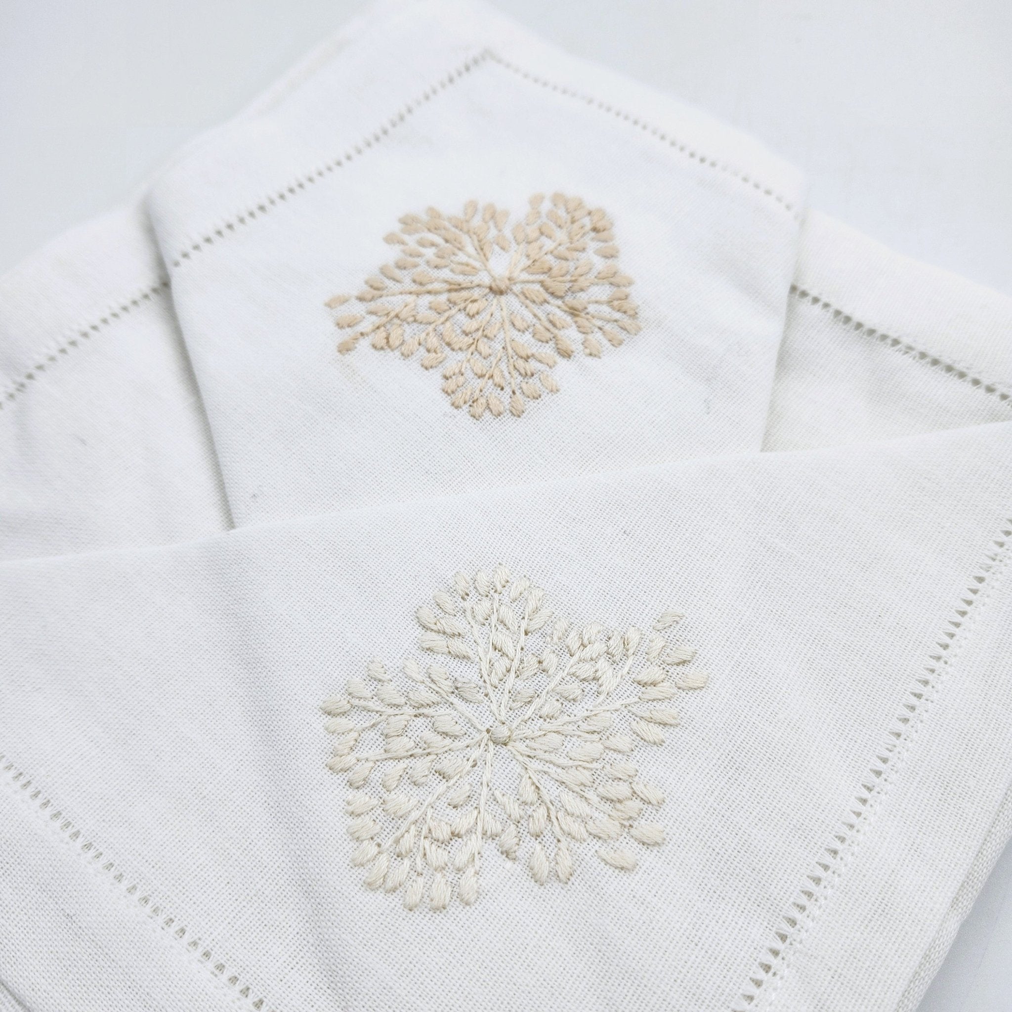 Beige floral hand embroidered white linen napkins, detail view