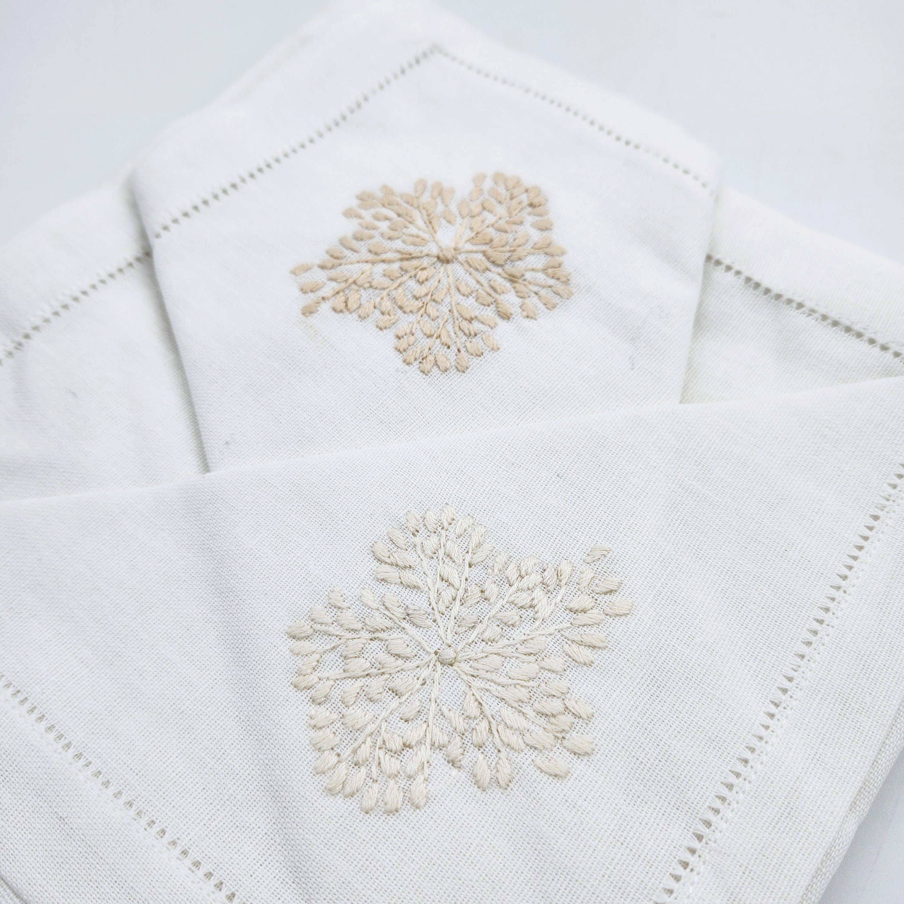 Beige floral hand embroidered white linen napkins, detail view