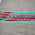 Multicoloured striped pashmina shawl with a deep hand-embroidered border in vibrant contrasting colours.