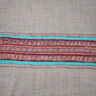 Pink striped 100% pashmina shawl with a deep hand-embroidered border at either end and stitched sides.