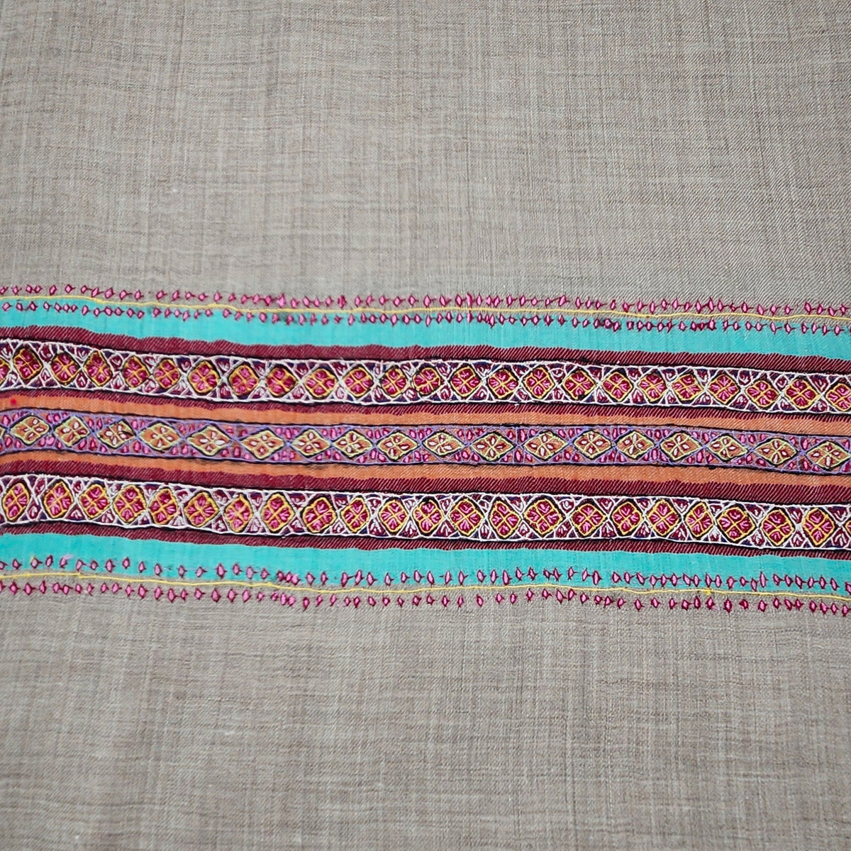 Pink striped 100% pashmina shawl with a deep hand-embroidered border at either end and stitched sides.