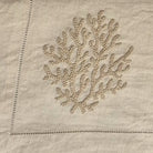 Natural linen runner with coral embroidery, understated, detail view