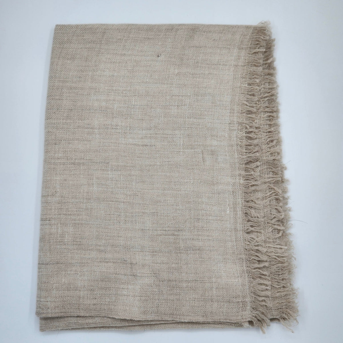 Cream hand-woven pashmina shawl in 100% pashmina, worn around the neck or draped over the shoulders.