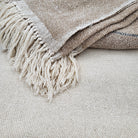 Cream silk handwoven throw with deep beige border, fringed