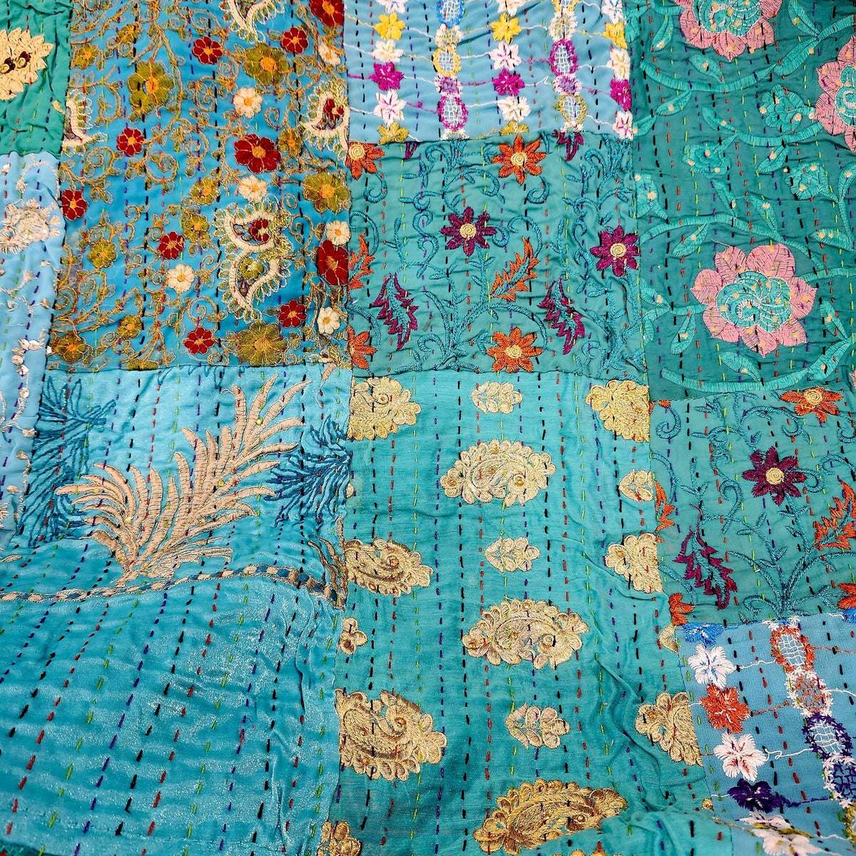 Kantha patchwork single quilt in turquoise, a patchwork of blue silk embroidered fabrics, 150 by 225cm.