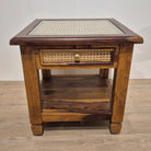 Teak bedside cabinet with a cane top under glass and a cane drawer front with a brass handle, 48cm cubed.