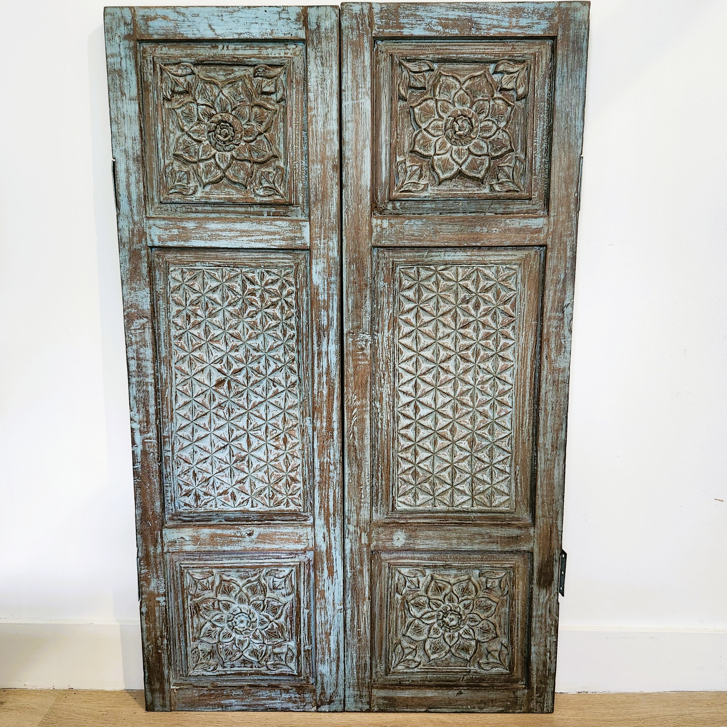 Pair of vintage Indian carved teak window shutters, distressed paint, 109 x 66cm