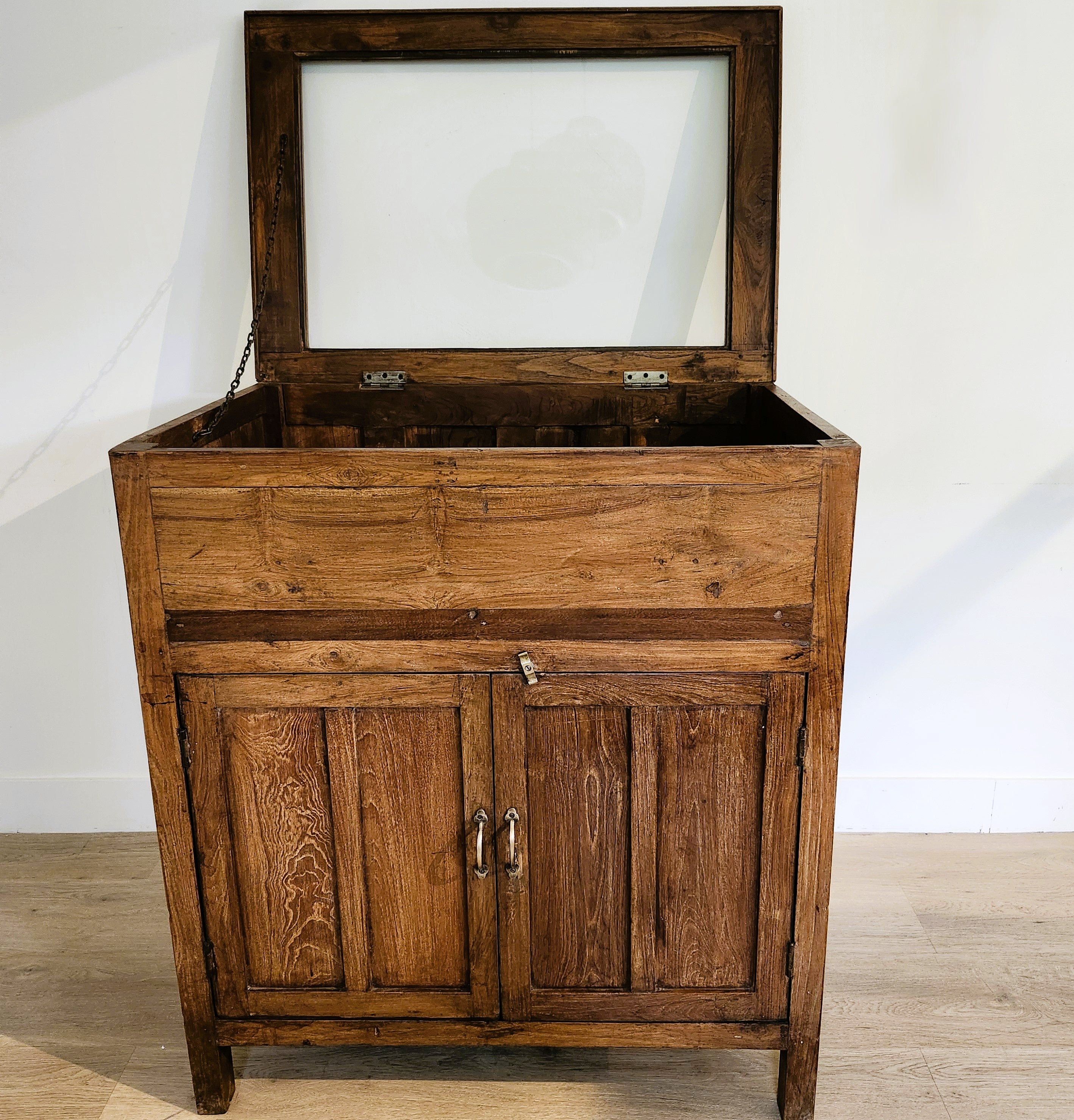 Teak chest with lift-up glass display top, styled