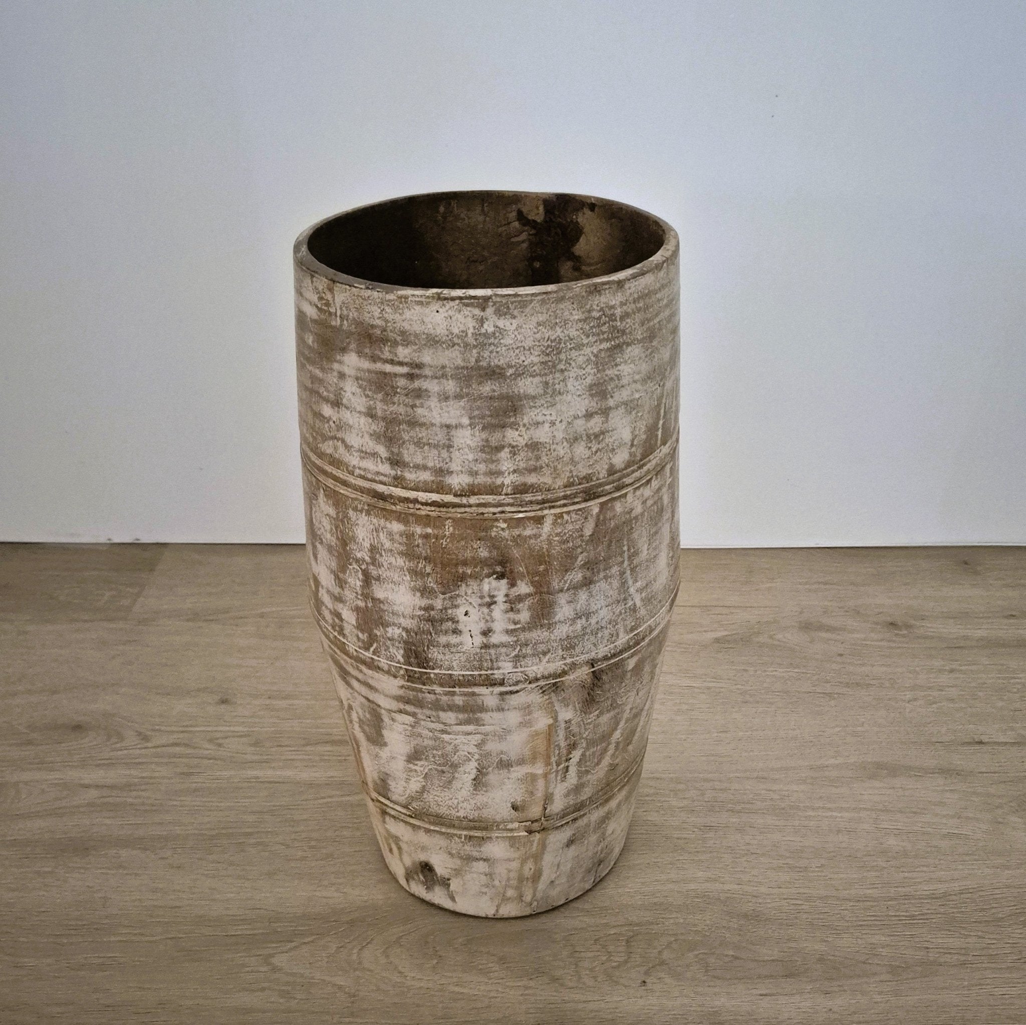 Wooden umbrella stand in a whitewash finish with a metal tray in the base, 23cm in diameter and 43cm high.
