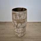 Wooden umbrella stand in a whitewash finish with a metal tray in the base, 23cm in diameter and 43cm high.