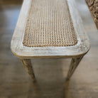 Cane-topped bench in limed mango wood with fluted legs