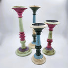 Painted wood candle stands in matte pastel colours, rustic Rajasthan style