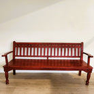 Vintage teak bench in red paint with ikat cushion, 183cm long