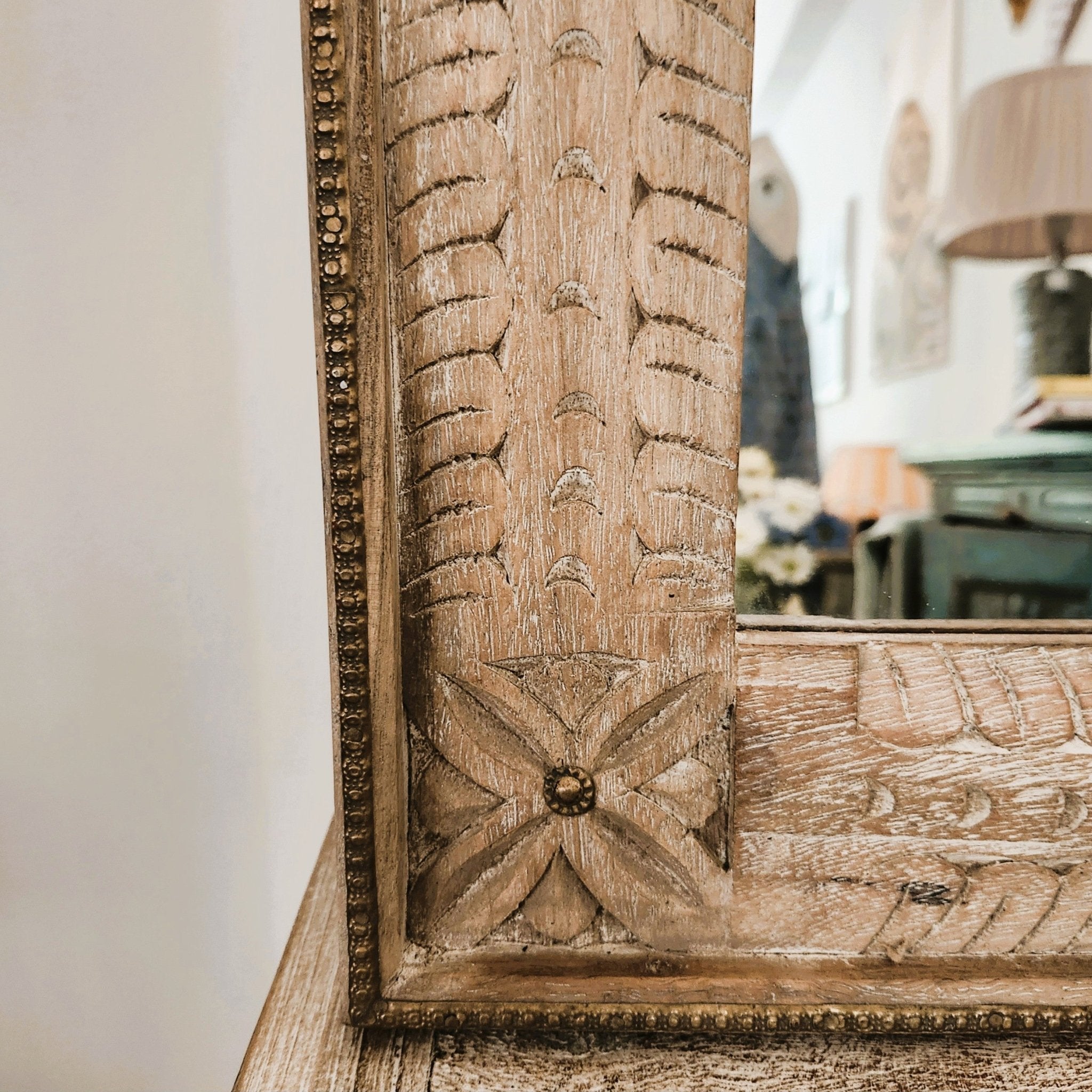 Carved wood mirror corner detail