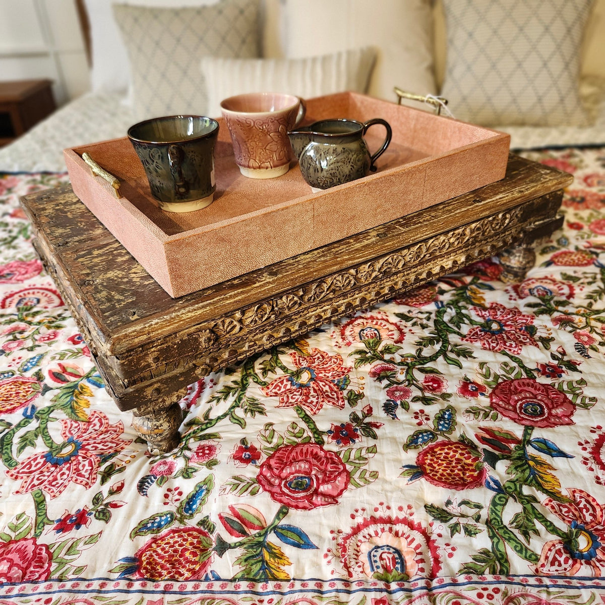 Another styled view of the carved teak bajot, a low table traditionally used for prayer rituals, 70 by 44cm and 19cm high